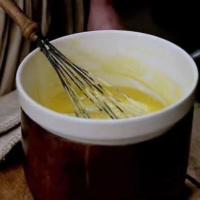 The Chef Mixes the Sauce in a Saucepan Using the Whisk. Master