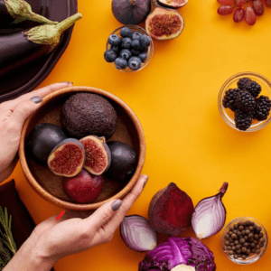 person holding a bowl of fresh fruits