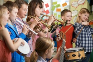 a group of kids playing wind instruments and drums